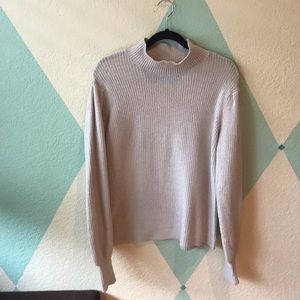tan colored turtleneck long sleeve top.